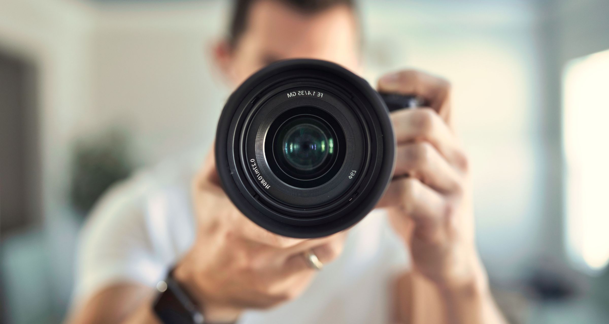 Man pointing camera lens at the camera. Why the Right Images Can Make or Break Your Website